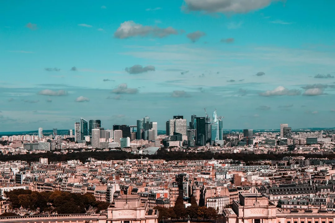 Cityscape with modern skyscrapers in the distance and traditional buildings in the foreground under a blue sky, offering stunning skyline views Palma reminiscent of a luxurious Cala Major penthouse.