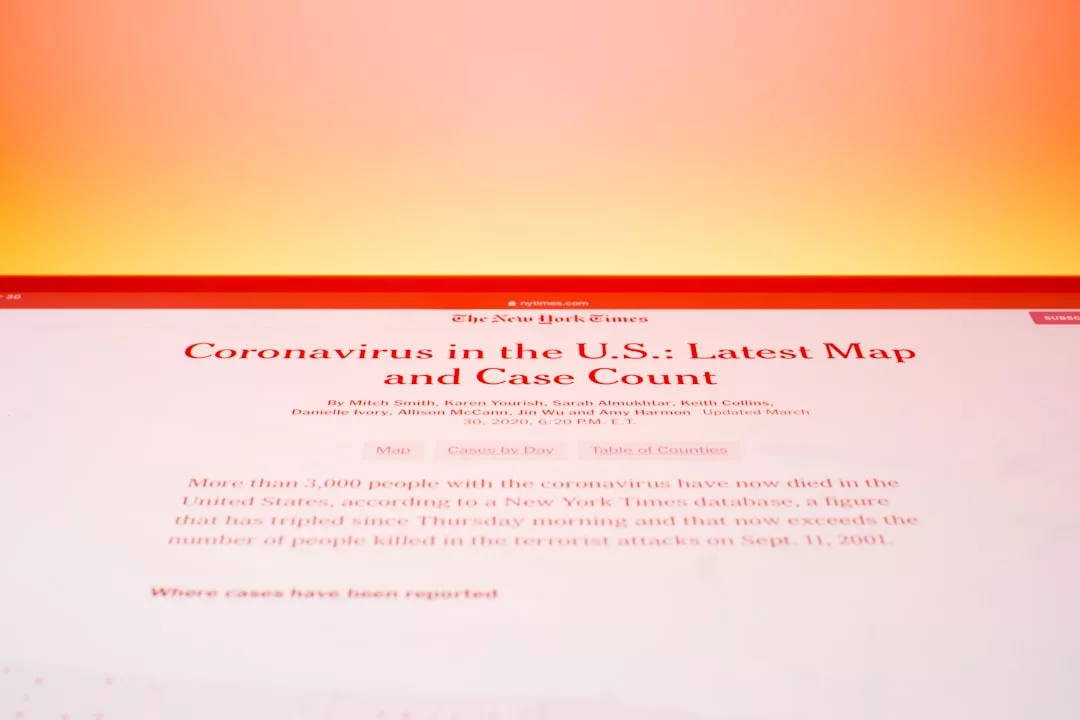 A computer screen displays a New York Times article about coronavirus maps and case counts in the U.S., alongside a compliance guide for short-term rental licensing.