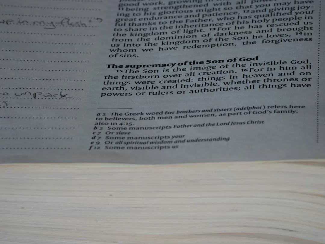 A close-up of a Bible page showing Colossians 1:15-17 and related study notes at the bottom, perfect for quiet reflection in your Cala d’Or villa. Ideal inspiration for those reviewing vacation villa agreements or a villa contract.